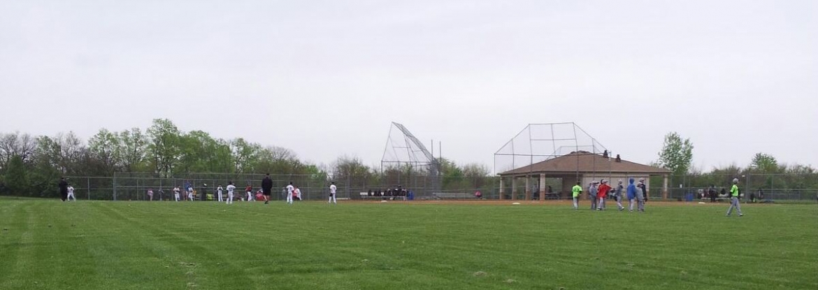 people playing baseball on a field